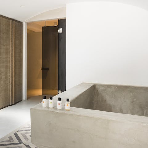 Sink back into the oversized tub in one of the sleek bathrooms