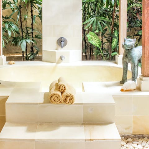 Unwind in the large outdoor bath tub after a day of discovering Bali