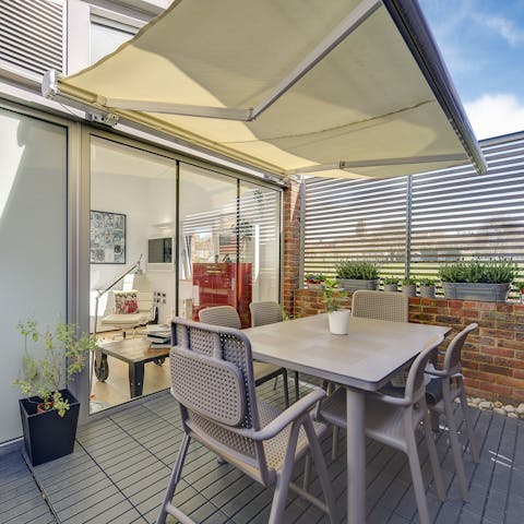 Enjoy breakfast on the stylish terrace with its retractable sunshade