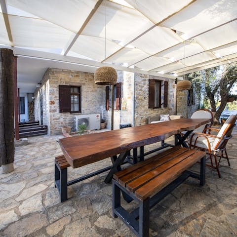 Share leisurely meals together on the family-style table, under the shade of the pergola