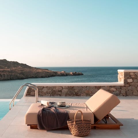 Lounge by the infinity pool and soak up the views of the Aegean Sea