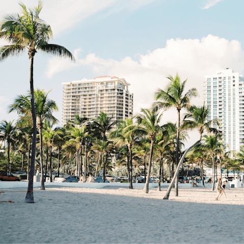 Sunbathe on Miami's sandy beaches, a fifteen-minute ride from home