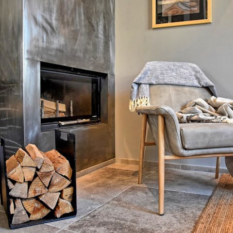 Place some wood in the modern fireplace and get toasty next to the crackling flames