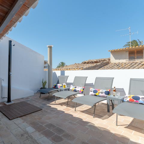Bask beneath cloudless Balearic skies on the rooftop terrace