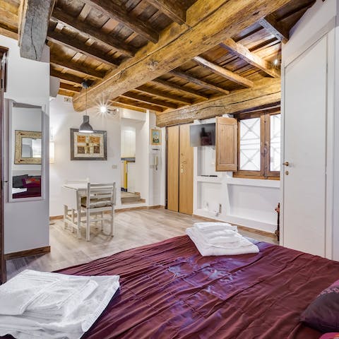 Admire the traditional, rustic timber beamed ceilings as you lie back in bed