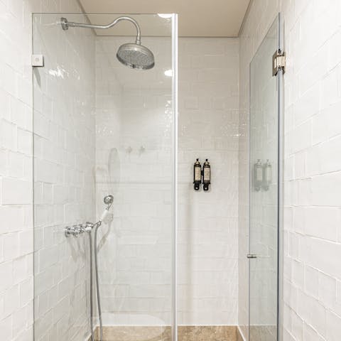 Relax and unwind beneath the rainfall shower after a day of sightseeing