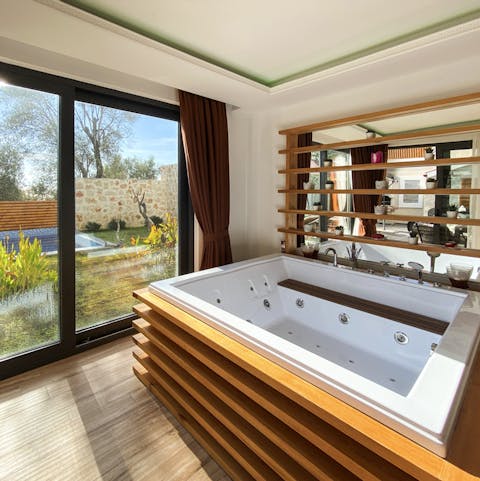 Unwind in the large Jacuzzi bathtub in the main bedroom, with direct access to the garden