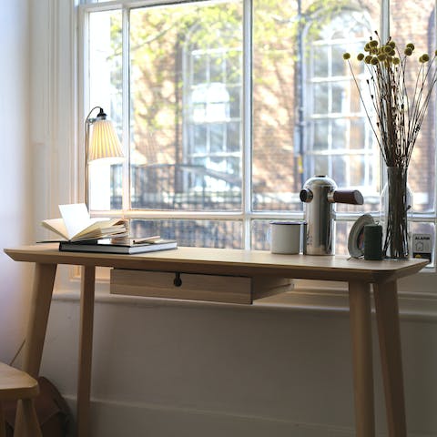 Catch up on work at the living room's window-side desk