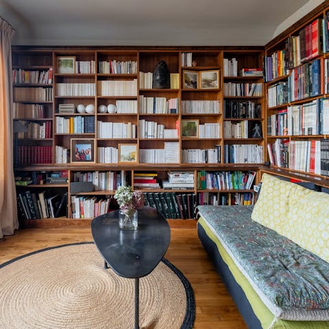 Get cosy with a book while relaxing in the home library