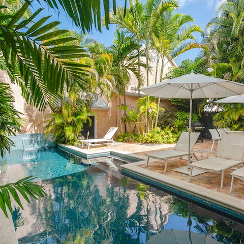 Lounge by the pool in your private tropical paradise