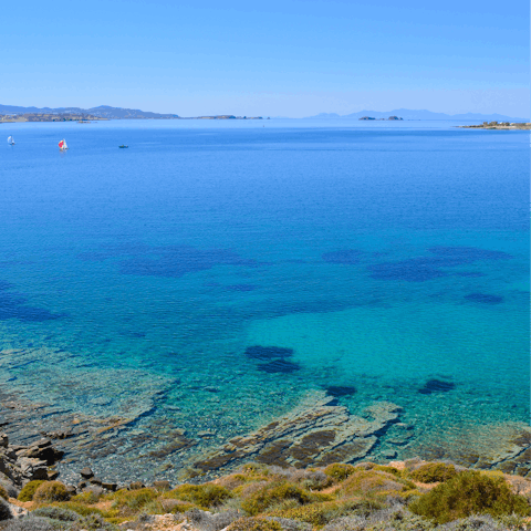 Walk for twenty-eight minutes or drive for six-minutes and you'll come across Paralia Agia Irini - a peaceful beach tucked in by palm trees