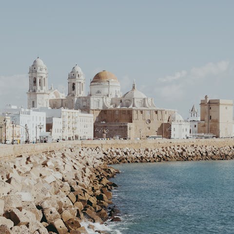 Visit the beautiful Catedral de Cádiz before enjoying a walk along the sea