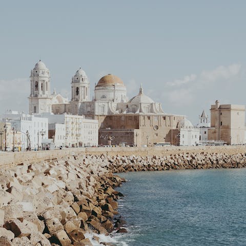 Visit the beautiful Catedral de Cádiz before enjoying a walk along the sea