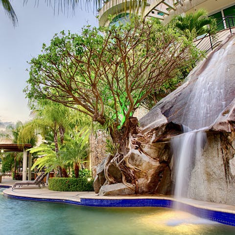 Cool off under the waterfall in the infinity pool