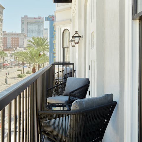 Sip your morning coffee on the private balcony overlooking Canal Street