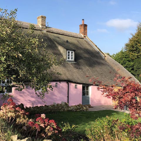 Stay in a fairytale pink thatched cottage
