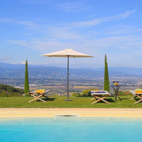 Pour yourself a glass of Tuscan wine and admire the stunning views over the valley