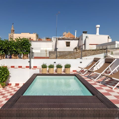 Take in the glimpses of La Giralda from the shared plunge pool