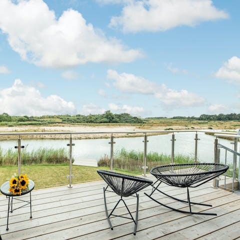 Relax out on the deck in the seating area and enjoy the views across the water