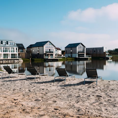 Head over to the communal lake beach area and relax on a sun lounger
