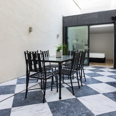 Dine alfresco on the private patio with its black and white tiles
