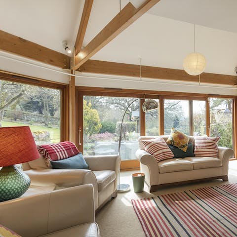 Get cosy in the bright lounge with panoramic views of the outdoors