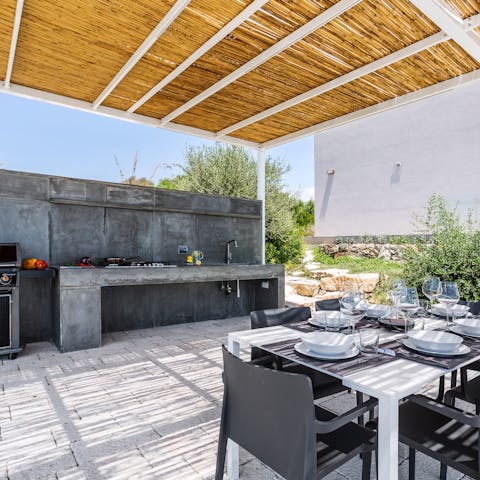 Cook a meal at the outdoor kitchen and dine alfresco