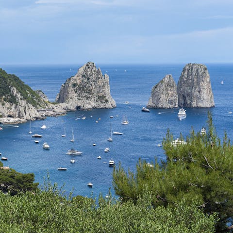 Marvel at the Faraglioni rock formation