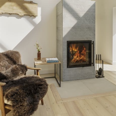 Curl up on a sheepskin by the ceramic Nordic wood burning stove