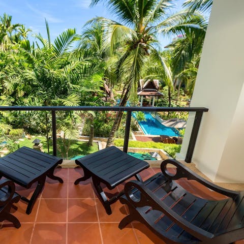 Take in tropical views from the private balcony overlooking the pool and gardens 