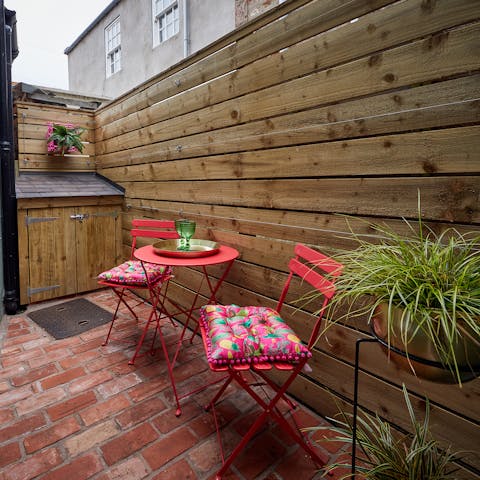 Savour a glass of wine on your private patio, with its brightly coloured furniture and pretty plants