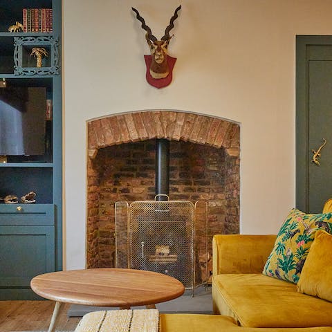Get cosy in front of the exposed-brick fireplace, sinking into the comfortable sofas