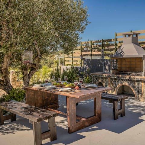 Sit down to an alfresco barbecue feast in the shade of the olive tree