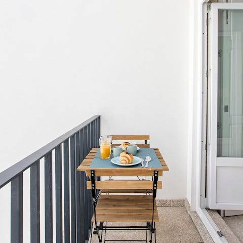 Step onto the balcony and enjoy the simple magic of city living – it's the perfect spot to enjoy a pastel de nata