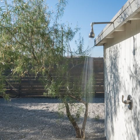 Freshen up in the outdoor shower after a hot day in the wild desert