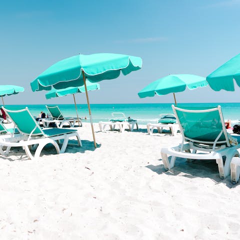 Relax on the pristine white sands of Miami Beach,  under a five-minute stroll away