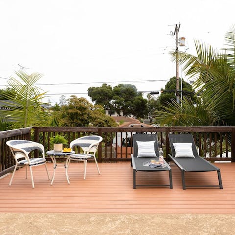 Sunbathe amidst the palms on the tranquil upper deck