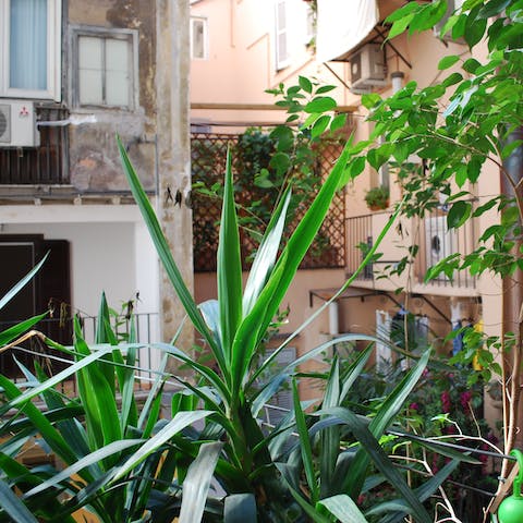 Peer over the leafy balconette with your morning espresso in hand