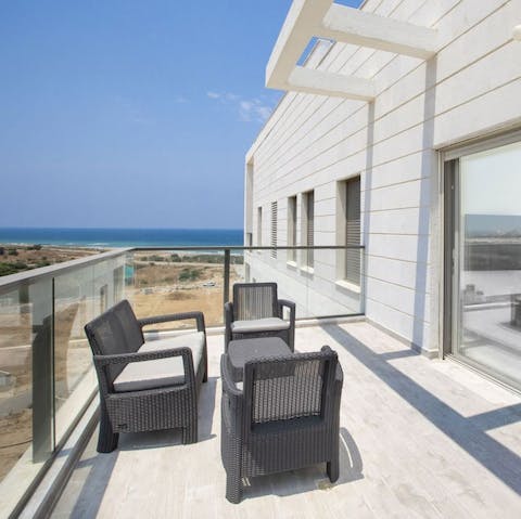Take in sparkling views of the Mediterranean Sea from the private balcony 