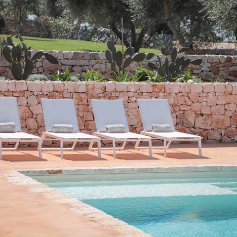 Relax in the Puglian sun next to the azure pool