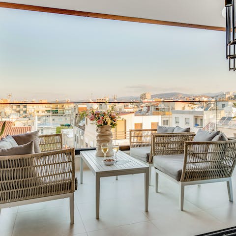 Enjoy a glass of wine on the balcony before heading into town for dinner