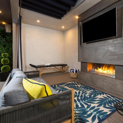 Snuggle up by the outdoor fireplace for an open-air movie night