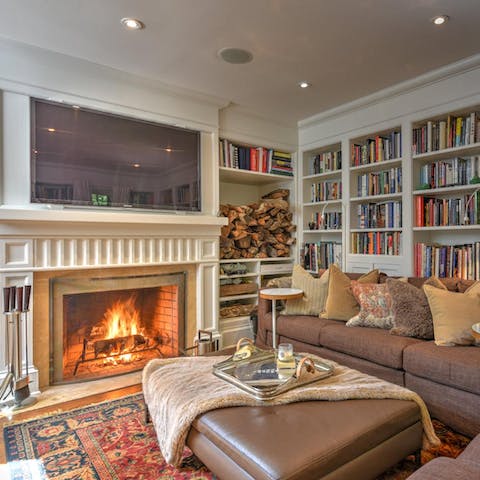 Relish in the home comfort of a cosy library and an open fire