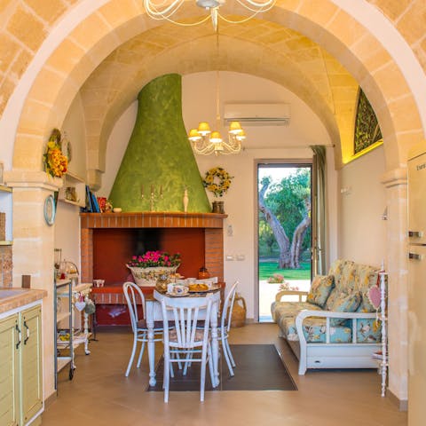 Admire the traditional features like the fireplace and exposed stone