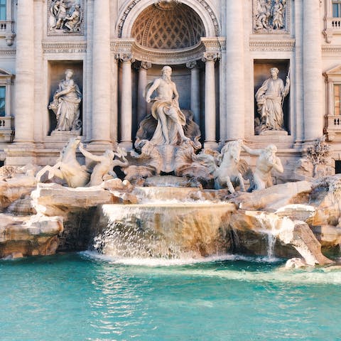 Take a short walk to admire the stunning marble sculptures of the historic Trevi Fountain