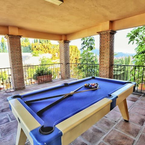 Let the drinks flow during a jovial game of pool in the evening