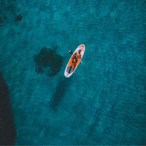 Explore the shallow waters of Chalk Sound lagoon