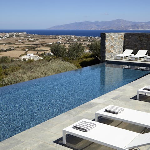Swim laps in the infinity pool with a beautiful view over Paros