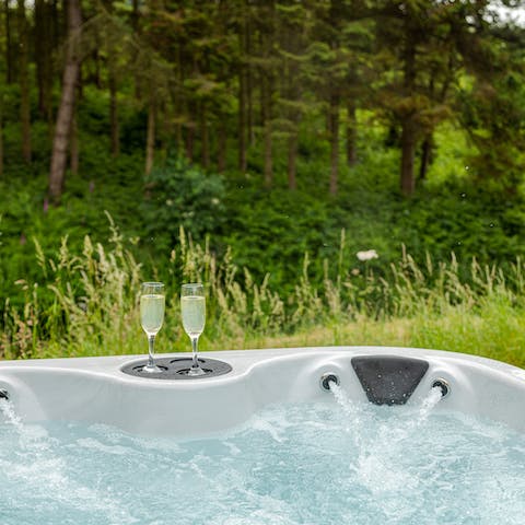Relax in the hot tub with a glass of fizz