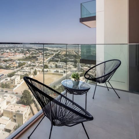 Sit out on the glass-fronted balcony while gazing out across Zabeel Park